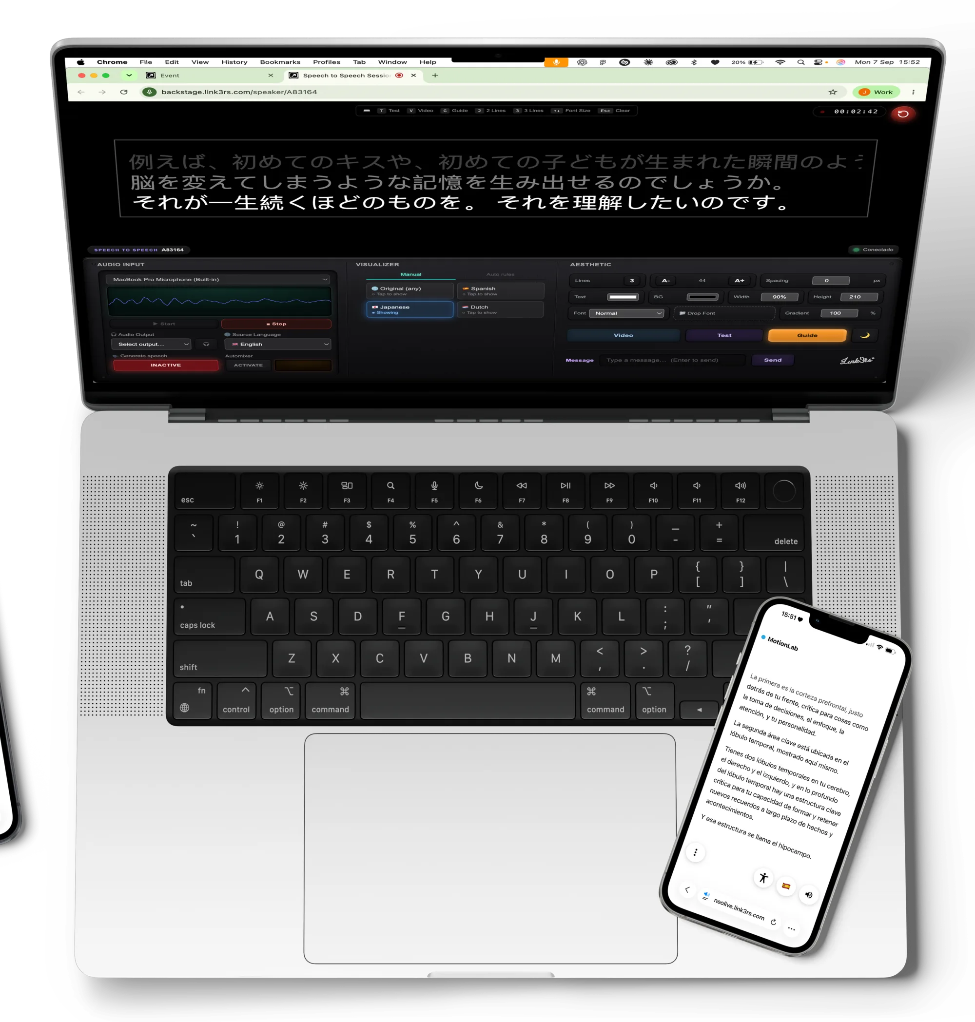 A MacBook seen from above running the Backstage speaker interface, with an attendee's phone showing the live translation